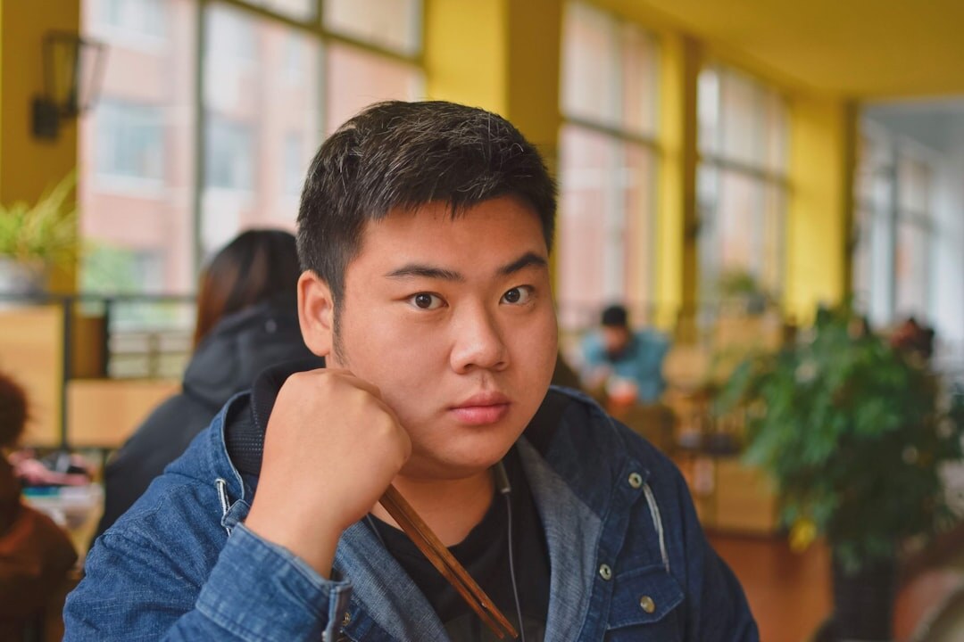 Person listening attentively during a conversation with hand near ear