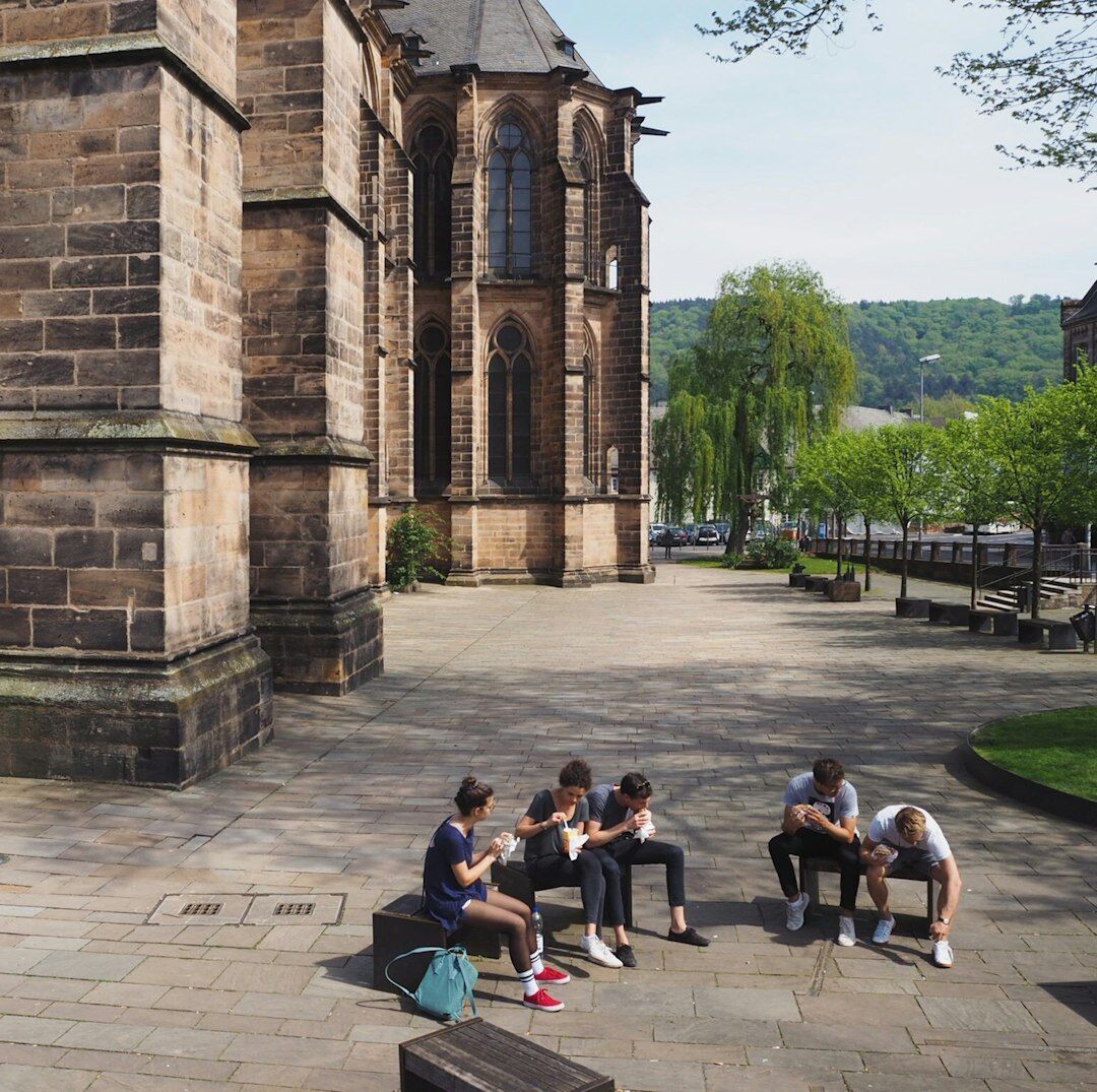 Friends sitting in a circle laughing together outdoors