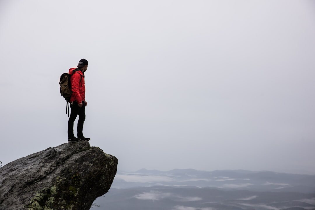 person climbing mountain